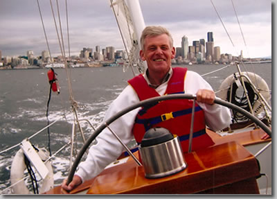 Charles Fawcett, artist, at the helm of the yawl Carlyn, in Seattle